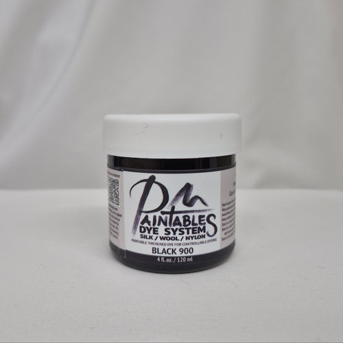 A jar of Paintables Dye System Black 900 dye, featuring a white lid and a black-and-white label, set against a draped white fabric background.