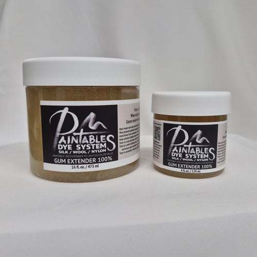 A 16oz white plastic jar of Paintable Dye System Gum Extender 100% and a 4oz white plastic jar of Paintable Dye System Gum Extender 100% on a white fabric background.
